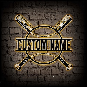 May include: A black baseball bat and ball design with a yellow outline. The word "CUSTOM NAME" is in the center of the design.