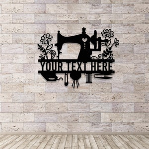 May include: Black metal wall art featuring a sewing machine, flowers, and sewing tools. The text "YOUR TEXT HERE" is displayed prominently. The design is suitable for a craft room or sewing enthusiast.