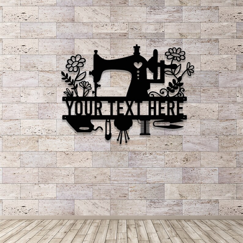 May include: Black metal wall art featuring a sewing machine, flowers, and sewing tools. The text "YOUR TEXT HERE" is displayed prominently. The design is suitable for a craft room or sewing enthusiast.