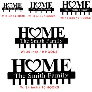 Op de afbeelding: Zwart metalen "HOME" bord met een hart in plaats van de "O", en "The Smith Family" eronder. Verkrijgbaar in verschillende maten, van 25 cm breed met 4 haken tot 61 cm breed met 10 haken.
