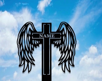 May include: Black metal cross with angel wings on either side. The cross has a nameplate that reads "NAME".