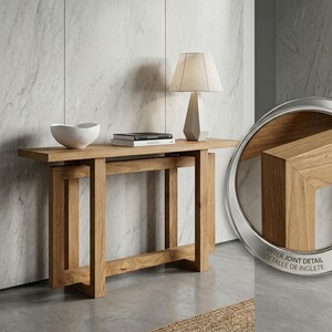 May include: A light oak console table with a rectangular top and a lower shelf. A white bowl, books, and a beige lamp sit on the table. The image includes a close-up of the miter joint detail.
