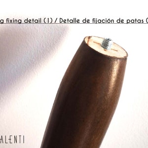 May include: Close-up of a wooden table leg with a metal screw detail. The leg is brown and has a smooth finish. The screw is silver and is visible at the top of the leg.
