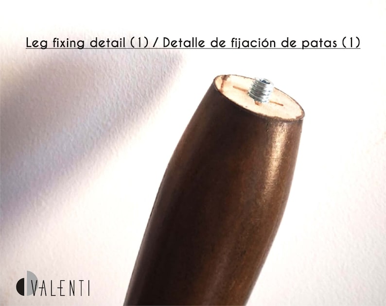 May include: Close-up of a wooden table leg with a metal screw detail. The leg is brown and has a smooth finish. The screw is silver and is visible at the top of the leg.