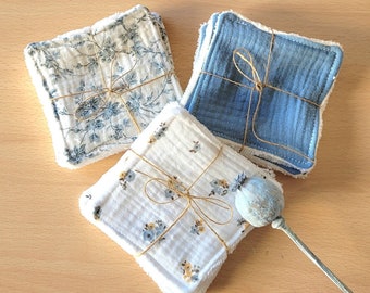 May include: Three sets of reusable makeup remover pads. One set is white with a floral pattern, one is white with a small floral pattern, and one is blue with a white border.