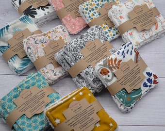 May include: A collection of reusable makeup remover pads made of cotton fabric with various colorful patterns. The pads are stacked in piles and have a brown paper label with text in French. The text on the label reads "Les tampons démaquillants en coton bio sont lavables et réutilisables. Ils sont doux pour la peau et respectueux de l'environnement.  Ils sont parfaits pour démaquiller le visage et les yeux.  Ils sont également parfaits pour nettoyer le visage et le corps.  Ils sont faciles à utiliser et à entretenir.  Ils sont durables et économiques.  Ils sont un excellent choix pour les personnes soucieuses de l'environnement.  Ils sont disponibles dans une variété de couleurs et de motifs.  Ils sont un cadeau idéal pour les femmes et les hommes.  Ils sont un excellent moyen de réduire les déchets et de prendre soin de la planète."