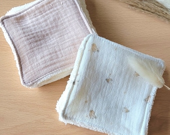 May include: Two square-shaped reusable makeup remover pads. One pad is a light brown color and the other is white with a small brown bird pattern.