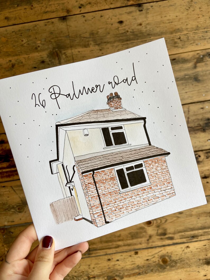 May include: A hand-drawn illustration of a house with a brick exterior and a brown roof. The house has two windows and a chimney. The address "26 Palmer Road" is written in cursive above the house.