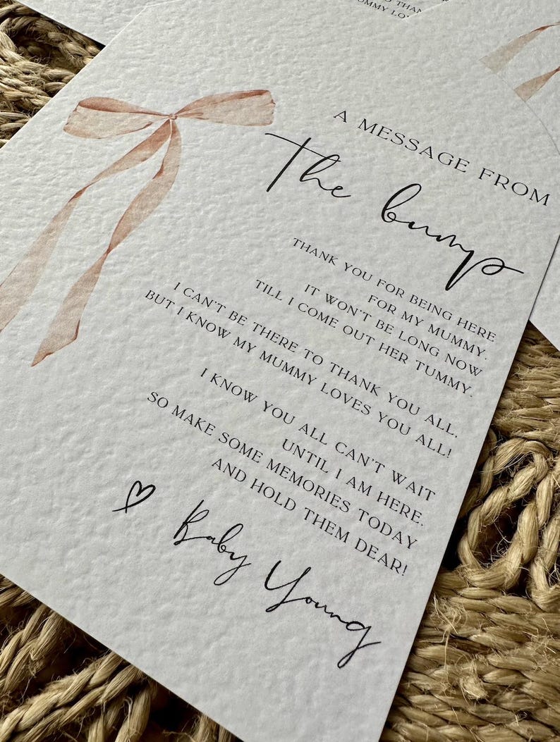 May include: A white card with a pink ribbon illustration and the text "A message from the bump". The card includes a message from the bump to the mother thanking her for being there and expressing excitement for the baby's arrival. The card is signed "Baby Young".