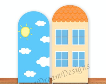 May include: Two backdrops for a photo booth. One backdrop is a blue sky with white clouds and a yellow sun. The other backdrop is a yellow house with orange roof and blue windows. The text "Yang Dream Designs" is visible at the bottom of the image.