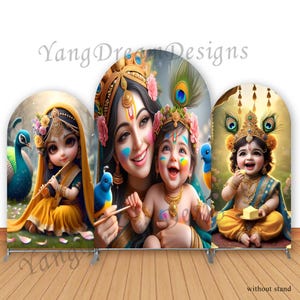 May include: Three colorful backdrops featuring Hindu deities. The first backdrop shows a young girl dressed in yellow and blue holding a flute. The second backdrop shows a woman with blue and green makeup holding a baby boy. The third backdrop shows a young boy dressed in yellow and blue holding a piece of butter.