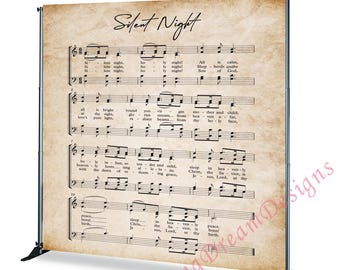 May include: A backdrop featuring the sheet music for "Silent Night" printed on aged paper. The text and musical notes are in black, set against a beige background. The backdrop is supported by a black metal frame.