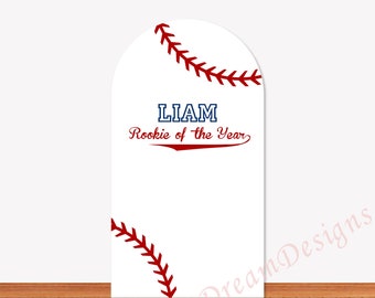 May include: White baseball-themed sign with red stitching details and the text "LIAM Rookie of the Year" in blue and red. The sign is arched at the top and stands on a wooden surface.