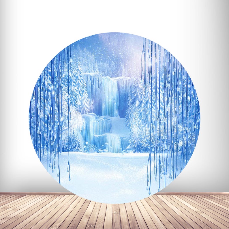 May include: A circular illustration of a frozen waterfall in a winter forest. The waterfall is surrounded by tall, icy trees and a snowy ground. The background is a light blue sky with falling snow.