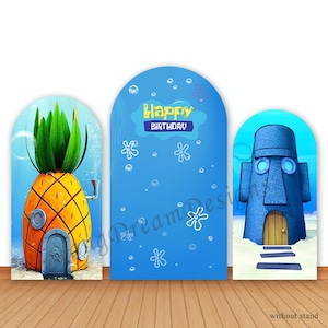 May include: Three cardboard cutouts for a birthday party. The centre cutout is blue with white bubbles and the text "Happy Birthday". The cutout on the left is a yellow pineapple house. The cutout on the right is a blue rock house with a door.