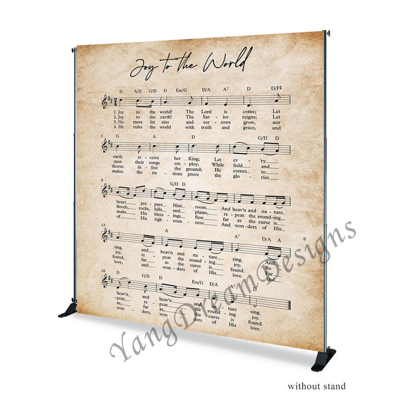 May include: A vintage-style backdrop featuring the lyrics and sheet music for the Christmas carol "Joy to the World". The backdrop is printed on a textured, cream-colored paper with brown accents. The text is in black.