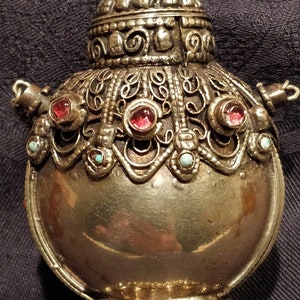 Richly decorated cosmetic bottle