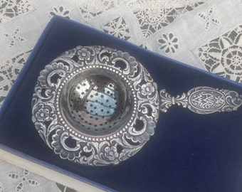 Fine, silver-plated tea strainer