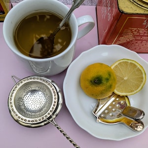Romantic, vintage tea strainer with lemon slice press, silver-plated