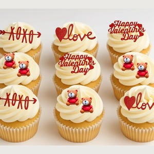 May include: Nine cupcakes with white frosting and decorative red accents. Some cupcakes have the text "xoxo" or "love", while others say "Happy Valentine's Day". Each cupcake is topped with a small teddy bear.