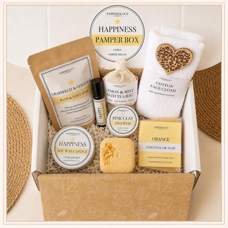 May include: A gift box containing a Grapefruit & Geranium bath soak, a Happy roller oil, a Lemon & Mint bath tea bag, a white cotton face cloth with a wooden heart, a Pink Clay face mask, a Happiness soy candle, and an Orange essential oil soap.