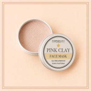 May include: A round silver metal tin containing fine pink clay powder, with a lid featuring the text PAMPEROLOGY LONDON, a gold star, PINK CLAY FACE MASK, X2 TREATMENTS, and 100% NATURAL. The lid is placed beside the open tin showing the powder.