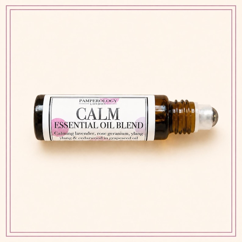 K&ouml;nnte beinhalten: Eine kleine Roll-on-Flasche aus bernsteinfarbenem Glas mit einer &auml;therischen &Ouml;lmischung. Das wei&szlig;e Etikett tr&auml;gt den Text PAMPEROLOGY LONDON, CALM ESSENTIAL OIL BLEND und listet Lavendel, Rosengeranie, Ylang-Ylang und Zedernholz in Traubenkern&ouml;l auf.