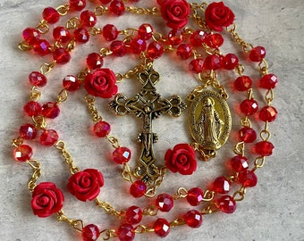 Handcrafted Prayer Rosary. Red crystals with Red rose beads accent and gold cross and medallion. Beautiful and thoughtful Christmas gift!