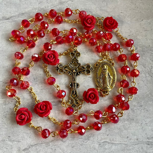 Handcrafted Prayer Rosary. Red crystals with Red rose beads accent and gold cross and medallion. Beautiful and thoughtful Christmas gift!