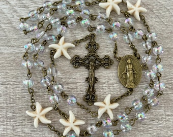Handcrafted Catholic Prayer Rosary. Clear crystals and starfish accent & bronze cross and medallion. Ocean rosary, sea rosary, under the sea