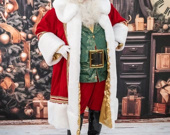 May include: Santa Claus wearing a red velvet coat with white fur trim, a green waistcoat, red trousers, and black boots. He is standing in front of a Christmas-themed backdrop.