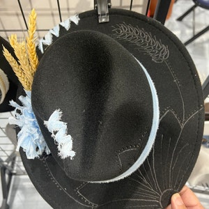 Black hand burned fedora