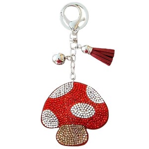May include: A red and white rhinestone mushroom keychain with a silver chain and a red tassel.