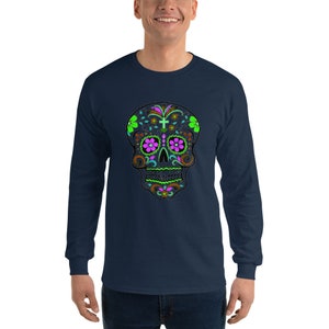 May include: A navy blue long-sleeve t-shirt with a colorful sugar skull design. The skull is decorated with flowers and a cross.