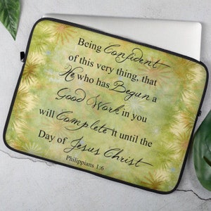 May include: A green and yellow laptop sleeve with a quote from Philippians 1:6, "Being confident of this very thing, that He who has begun a good work in you will complete it until the day of Jesus Christ."