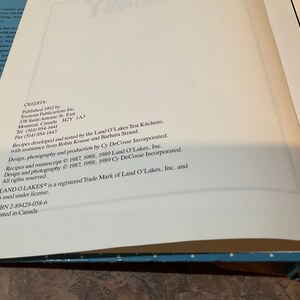 May include: A white page with black text listing credits for the Land O'Lakes cookbook. The text includes the publisher, contact information, and copyright information for the recipes and photography.