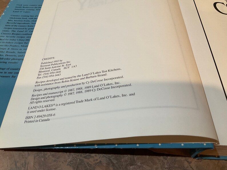 May include: A white page with black text listing credits for the Land O'Lakes cookbook. The text includes the publisher, contact information, and copyright information for the recipes and photography.