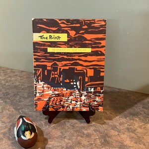 May include: A vintage book titled "The Print: An original art form for all" with a black and orange cover featuring a cityscape illustration.