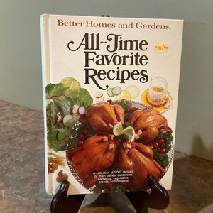 May include: A vintage cookbook titled "All-Time Favorite Recipes" by Better Homes and Gardens. The cover features a photo of roasted chickens on a silver platter with a green salad and a glass pitcher.