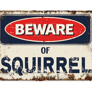 May include: A vintage-style metal sign with a white background and red and blue accents. The sign reads "Beware of Squirrel" in black lettering.