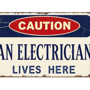 May include: A rectangular metal sign with a distressed finish. The sign features the word "CAUTION" in a red oval, above the text "AN ELECTRICIAN LIVES HERE" in navy blue. The background is off-white.