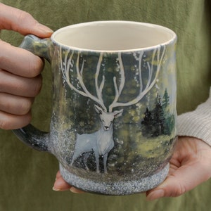 Ceramic mug  24 oz. with white stag and forested mountains. Eco-friendly gift.