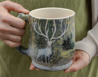 Ceramic mug  24 oz. with white stag and forested mountains. Eco-friendly gift.