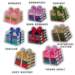 May include: A collection of eight embroidered patches, each depicting a stack of three books tied with a ribbon bow. The patches are labeled with text including Romance, Romantasy, Fantasy, Dark Romance, Thriller, Historical Fiction, Cozy Mystery, and Young Adult, featuring various color combinations of books and bows.
