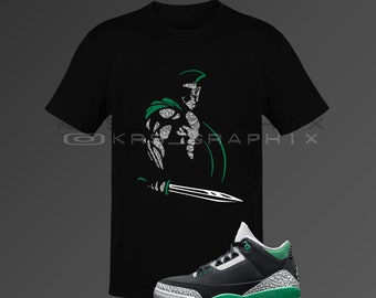 May include: Black t-shirt with a green and white graphic of a warrior holding a sword.  Black and green sneakers with a white sole.