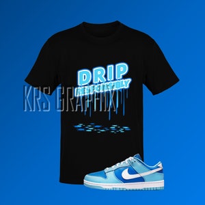 May include: Black t-shirt with blue text that says "DRIP RESPONSIBLY" and blue dripping paint. A pair of blue and white sneakers are in the bottom right corner of the image.