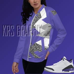 May include: A purple and white patterned bomber jacket with a zipper closure. The jacket has a gray and white geometric design. A white and purple sneaker with a gray sole is also pictured.