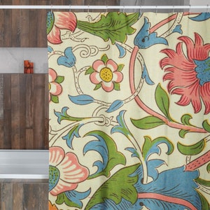 May include: A shower curtain with a floral pattern featuring pink, blue, and green flowers on a cream background.
