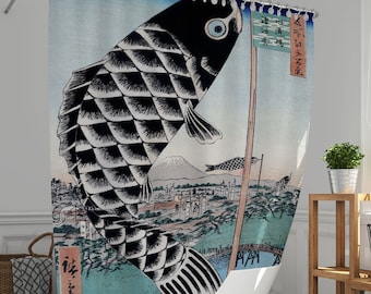 May include: A shower curtain featuring a traditional Japanese woodblock print of a black carp fish with a mountain in the background. The carp is swimming upwards with a flag attached to its tail. The flag has Japanese characters on it.