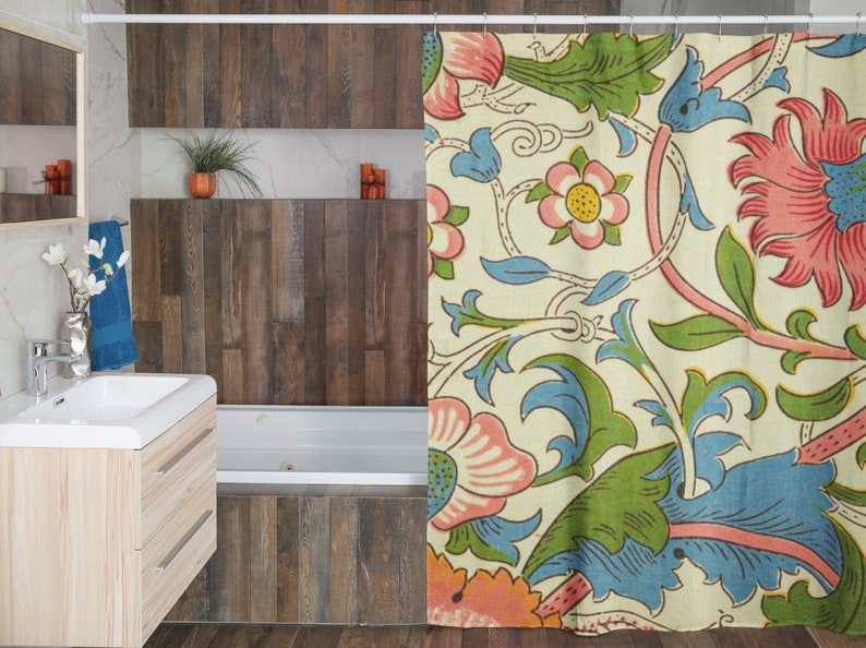 May include: A shower curtain with a floral pattern featuring pink, blue, and green flowers on a cream background.